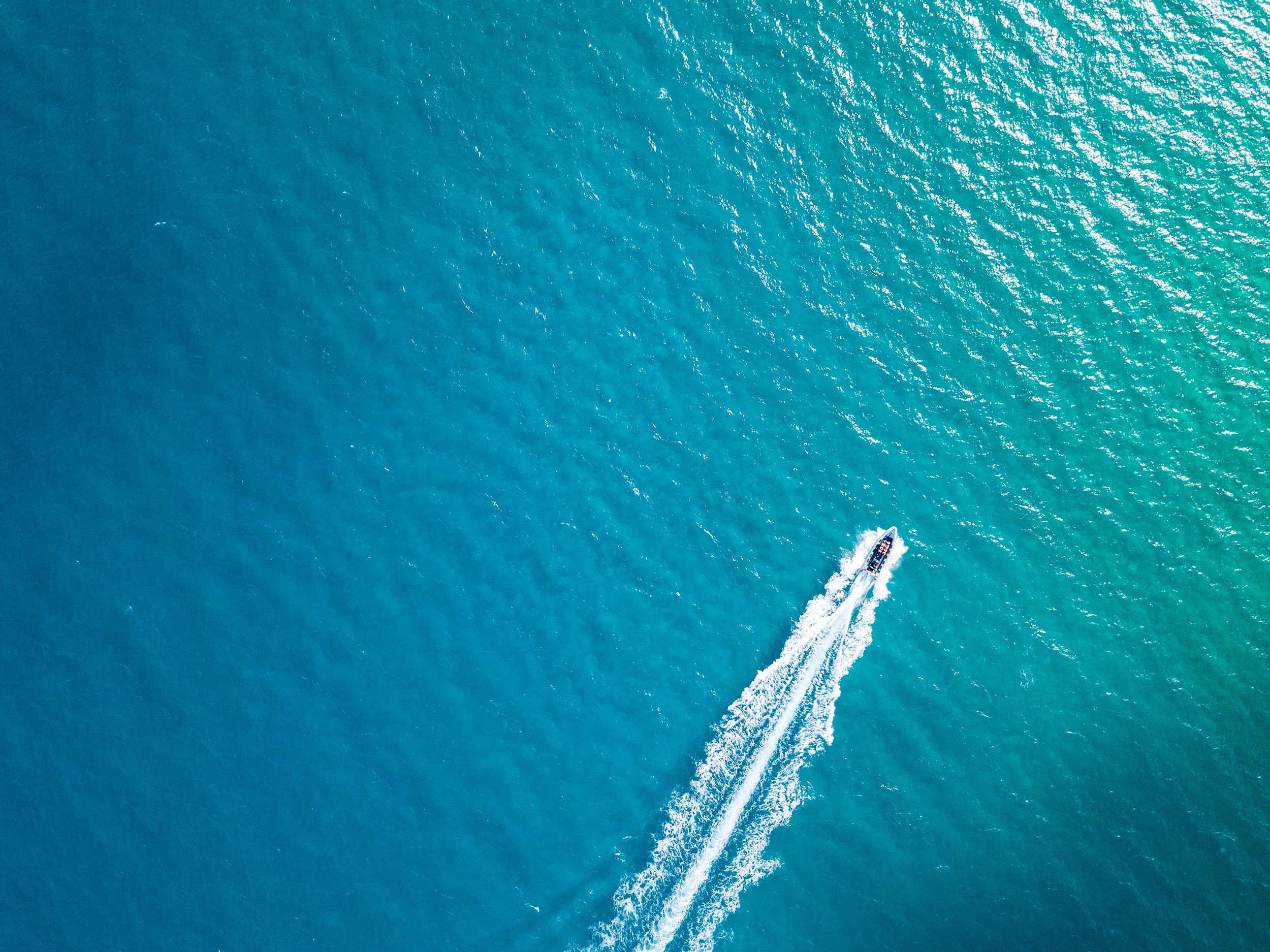 Boat Cruising on Turquoise Water